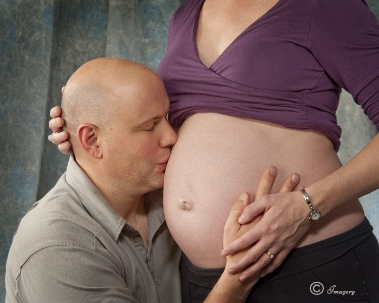 Professional Photo of Man Kissing Pregnant Woman's Stomach